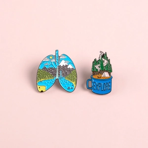 Creative enamel pin set featuring a lung-shaped landscape and explore campfire mug