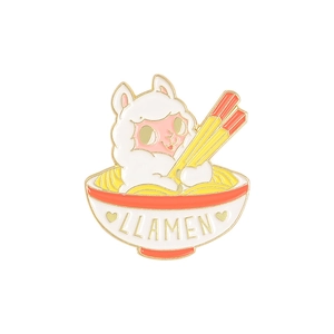Close-up of llama ramen enamel pin with gold LLAMEN text and cute white alpaca design