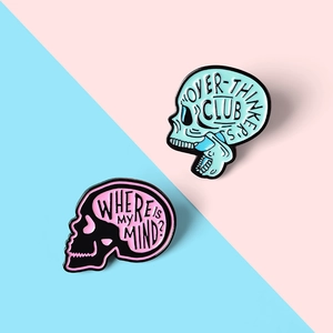Detailed macro of enamel skull pins featuring Over-thinker's Club and Where is My Mind text
