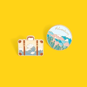 Cartoon enamel pin set with ocean suitcase and mountain adventure landscape designs