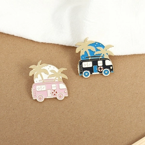 Creative mini camper and palm tree enamel pins in pink and black for outdoor lovers