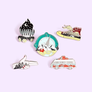 Outdoor adventure camping enamel pin set featuring bus, canvas shoes, and campfire