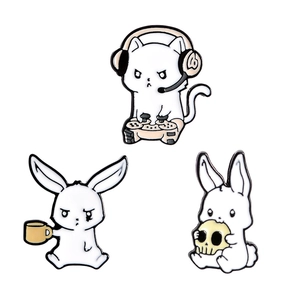 Three creative cartoon enamel pins featuring gaming cat, angry rabbit, and skull bunny set