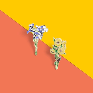 Exquisite enamel pins set featuring detailed iris and sunflower floral designs
