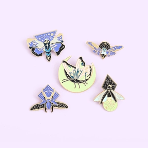 5-piece set of celestial insect enamel pins with moth, beetle, and crescent moon designs