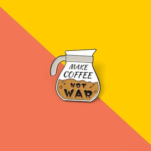 Detail of coffee pot enamel pin with Make Coffee Not War slogan on colorful background