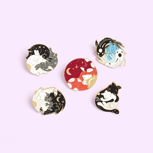 Set of five enamel pins featuring animals like fox, rabbit, and koi with yin yang celestial art