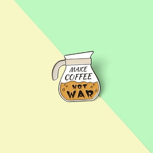 Detail of coffee pot enamel pin with Make Coffee Not War slogan on pastel background