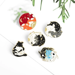 Five animal enamel pins including fox and koi fish in yin yang style on white background