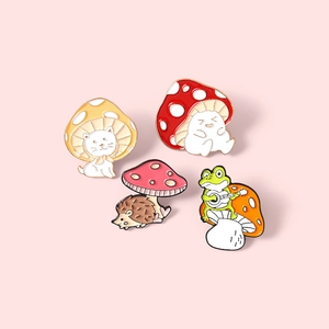 Cute enamel pin set featuring cartoon cat, hedgehog, and frog with mushroom motifs