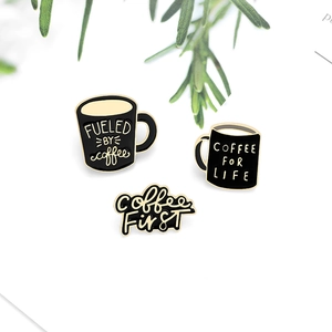 Cartoon coffee enamel pins set featuring black cups and Fueled by Coffee text on white background