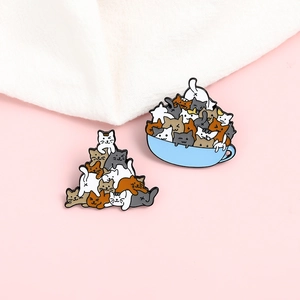 Cartoon cats stacked in a teacup enamel pin badge with colorful feline illustrations