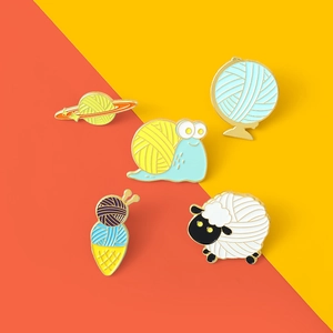 Creative enamel pins featuring wool ball planet, snail, sheep and ice cream cone designs