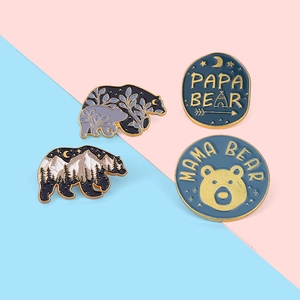 Enamel forest bear brooch set with Mama Bear and Papa Bear lettering on colorful background