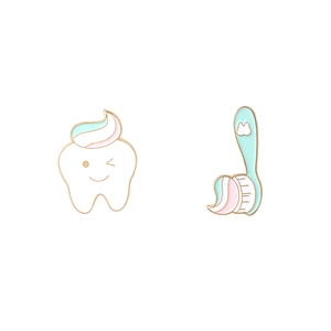 Creative enamel pin set featuring a smiling tooth with toothpaste and a green toothbrush