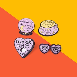 Set of four purple enamel pins with inspirational quotes on colorful background