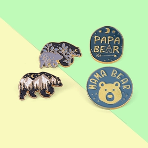 Set of four bear enamel pins with Papa and Mama Bear lettering and mountain scenery