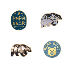 Set of four forest bear enamel pins with Papa Bear and Mama Bear text on white background