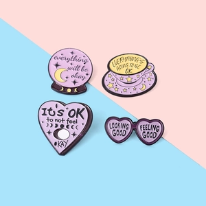 Set of 4 purple celestial enamel pins featuring crystal balls and motivational quotes