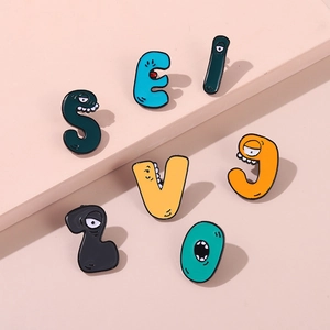 Detail of colorful Alphabet Lore monster enamel pins with cartoon painted alloy finish