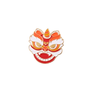 Detail of Chinese lion dance enamel brooch with red lacquer and gold metal plating