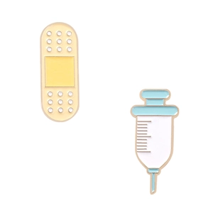 Creative enamel pin set featuring yellow bandage and blue syringe shaped alloy badges