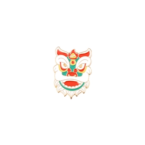 Detail of red Chinese lion dance enamel brooch with intricate gold metal edges