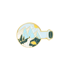 Detailed enamel pin showing a landscape in a bottle with snow mountains and a yellow tent