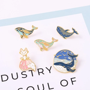 Cartoon animal enamel pins set featuring cute whales and a pink fox for clothes and bags