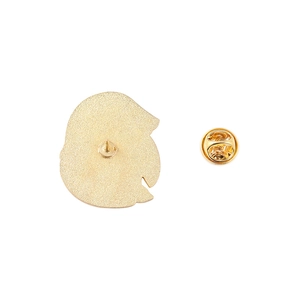 Detail showing the golden alloy brooch back with matte texture and butterfly clutch