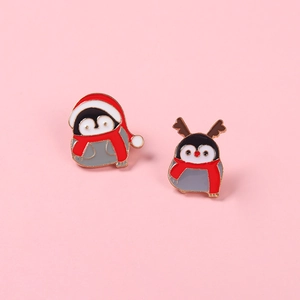 Cute set of two Christmas penguin enamel pins featuring Santa hats and reindeer antlers