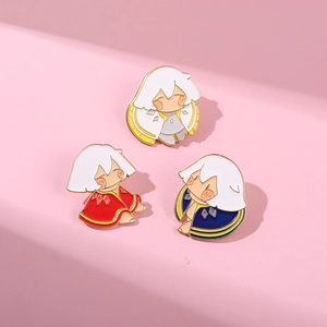 Detail shot of three Sky Game enamel pins featuring colorful cloaks on a pink background