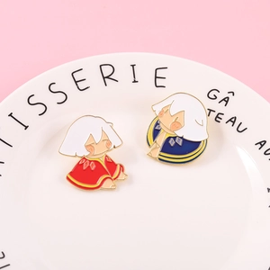 Macro detail of red and blue enamel Sky Children of Light pins on decorative porcelain