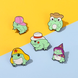 Set of five colorful frog enamel pins featuring wizard and cowboy hat designs on dual-tone background