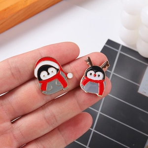 Cute Christmas penguin enamel pins featuring Santa hat and reindeer horns for winter decor