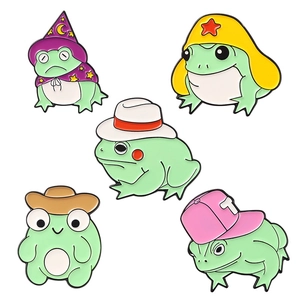 Set of five cute green cartoon frog enamel pins wearing colorful wizard and cowboy hats