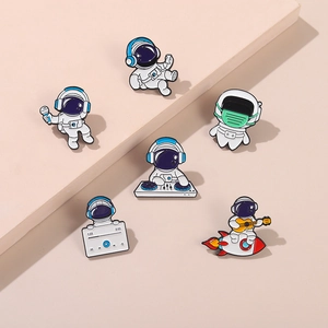 Set of six colorful enamel pins featuring cartoon astronauts and musical instruments