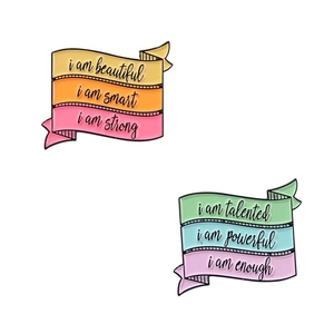 Motivational enamel banner pins with positive quotes on colorful striped flag backgrounds