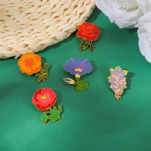 Exquisite floral enamel pins set featuring colorful rose and marigold metal badges