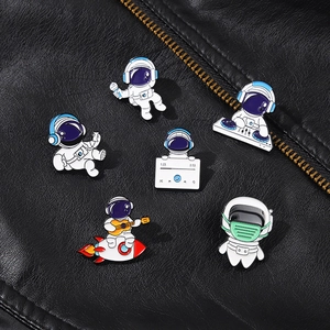 Detailed set of cartoon astronaut enamel pins with music themes on a black leather jacket