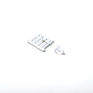 Back view of enamel pin with metal needle and transparent butterfly clutch fastener