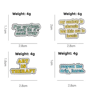 Detail view of four enamel letter pins with funny quotes like Art is Therapy