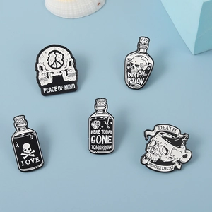 Flat lay of gothic skull pins including Peace of Mind and Death Potion badges on blue