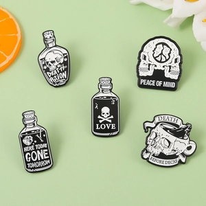 Detailed close-up of 5 Gothic skull enamel pins with Death Potion and Peace of Mind motifs