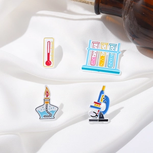 Science lab enamel pin set featuring microscope, test tubes, thermometer and alcohol lamp