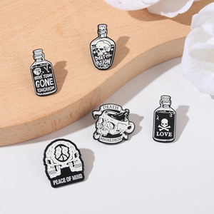 Gothic skull and potion enamel pin set in black and white finish for clothing