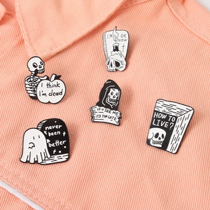Gothic skull and ghost black enamel pin set on a denim jacket collar for punk style
