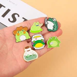 Funny cartoon frog enamel pins set featuring a cowboy frog and knife wielding frog charms