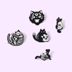 Detailed set of 5 black cat skull enamel pins with gothic moon and bone motifs