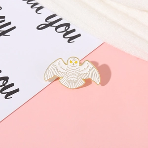 Creative flying owl enamel pin with white lacquer finish and gold metal accents